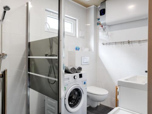 a white bathroom with a washing machine in it at Diune Resort at the seashore in Miedzywodzie for 7 persons in Międzywodzie