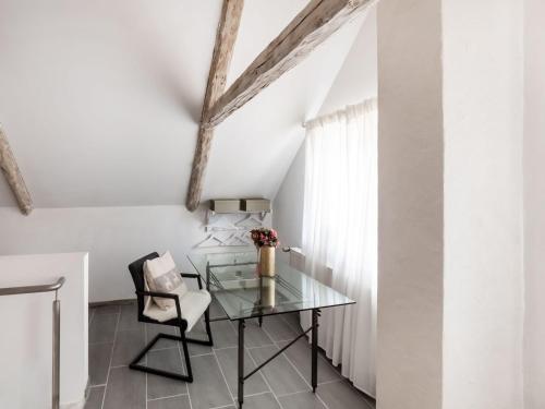 a glass table and a chair in a room at Luxurious holiday home with a nice private garden in Ditscheid