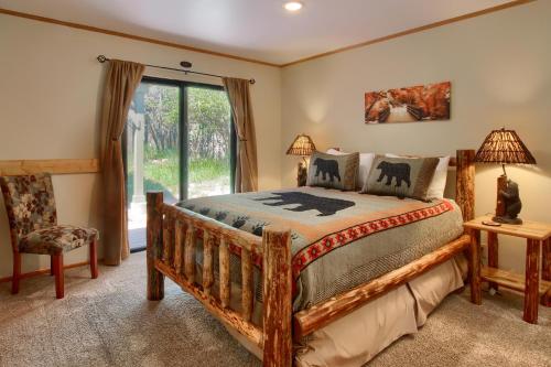 a bedroom with a bed and a chair and a window at Apple Tree Bear House in Yosemite West