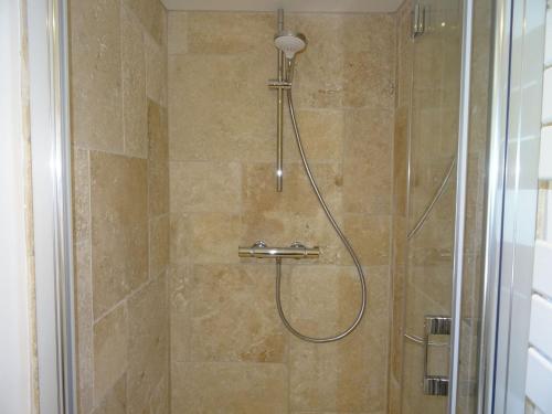 La salle de bains est pourvue d'une douche avec un pommeau de douche. dans l'établissement Pretty Penty by the sea in Plougasnou, à Plougasnou