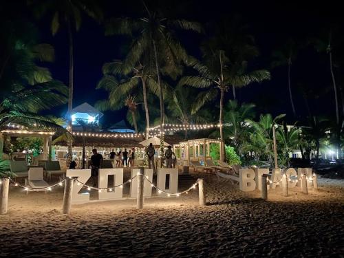 a beach with a sign that says hotel at night at Cozy 2 bdr condo, with pool area and free WIFI in Punta Cana