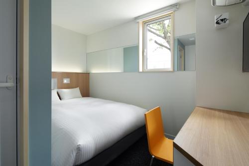 Voodi või voodid majutusasutuse Kamishihoro Hotel toas