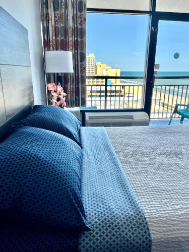 a bedroom with a bed and a large window at Ocean View Queen Suite 10th floor Myrtle Beach in Myrtle Beach