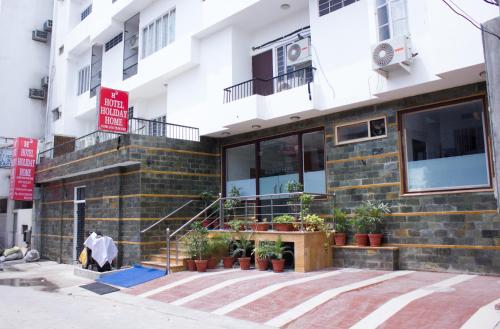 a man is standing outside of a building at Hotel Holiday Home in Jaipur