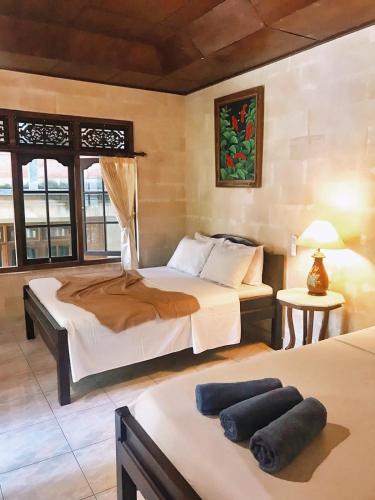a bedroom with two beds in a room at Darma Yogi House in Ubud