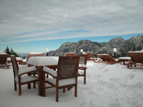 a table and chairs covered in snow on a roof at Alishan Hotel in Xianglin