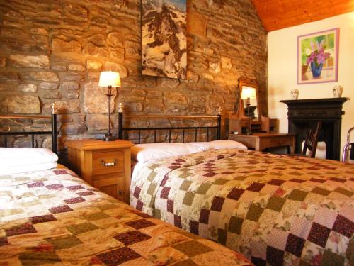 Postel nebo postele na pokoji v ubytování Druid Cottage