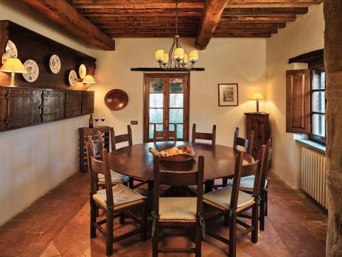 a dining room with a wooden table and chairs at Charming House in Umbria with Pool in Monte Castelli