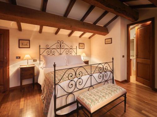 a bedroom with a large bed and a wooden floor at Charming House in Umbria with Pool in Monte Castelli