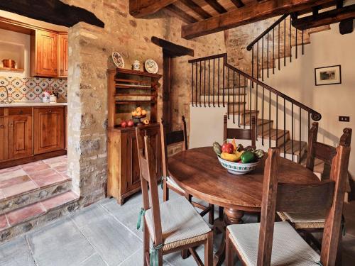 a kitchen with a wooden table with a bowl of fruit at Charming House in Umbria with Pool and Garden in Monte Castelli