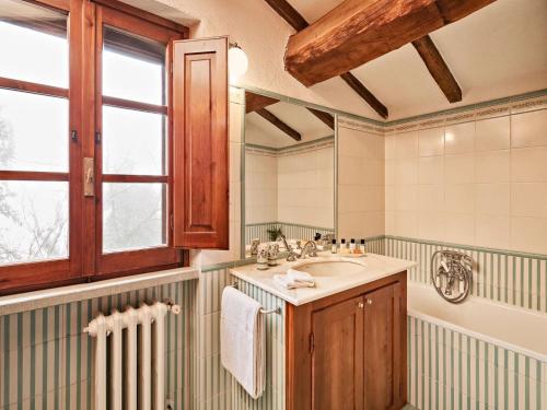 a bathroom with a sink and a mirror at Charming House in Umbria with Pool and Garden in Monte Castelli