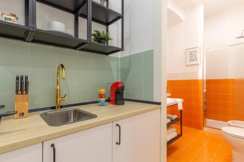 a bathroom with a sink and a toilet at Lovely and tiny Pied-à-terre in the City center in Trieste