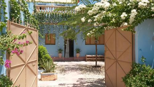 an entrance to a blue house with a gate and flowers at Villa Diletta Luxor in Luxor
