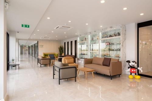 a lobby with couches and chairs in a pharmacy at The Pride Hotel Phitsanulok in Phitsanulok