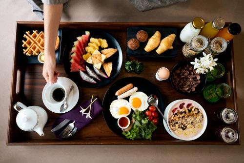 a tray of breakfast foods on a table at Pakasai Resort - SHA Extra plus in Ao Nang Beach