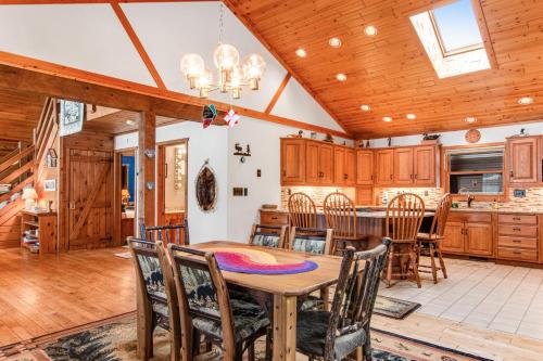 a dining room and kitchen with a table and chairs at Sailor's Point Lodge in Eagle River