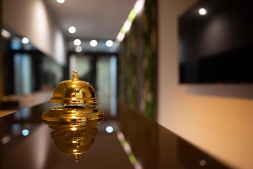 a gold bell sitting on top of a table at House Room Civico 56 in Crotone