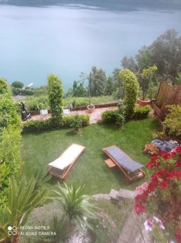 two lounge chairs on the grass in a yard at Giardino sul Lago SPA Jacuzzi in Castel Gandolfo