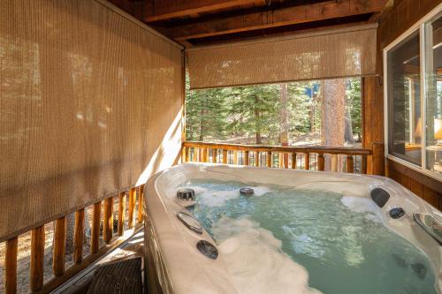 eine Whirlpool-Badewanne in einer Hütte mit Fenster in der Unterkunft Cochise Adventures in South Lake Tahoe