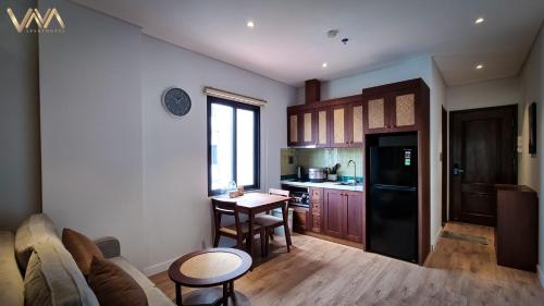 a kitchen with a couch and a table in a room at VNAHOMES APARTHOTEL in Hanoi