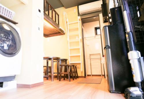 a laundry room with a refrigerator and some chairs at Japanese Modern House in Shinagawa in Tokyo