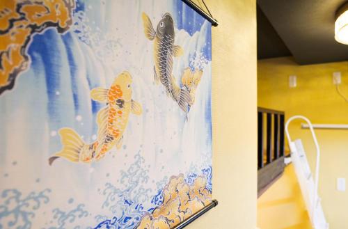 a curtain with goldfish on a wall at Japanese Modern House in Shinagawa in Tokyo