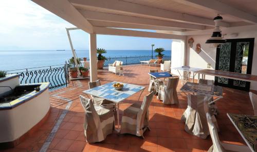 a patio with a table and chairs and the ocean at Due Relais - Panoramic Sea View Suites in Vietri sul Mare