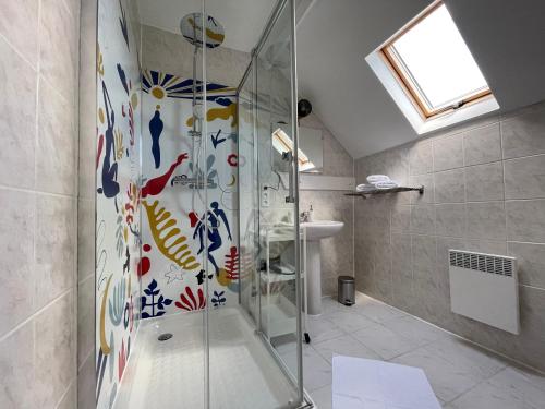 a bathroom with a shower and a sink at Gold - Ferme Delaunay in Saint-Côme-du-Mont
