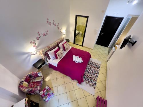 an overhead view of a bedroom with a bed and a couch at Due Relais - Panoramic Sea View Suites in Vietri sul Mare