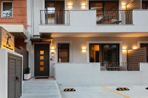 a facade of a house with a black door at 7 City Luxury Apartments in Rethymno Town