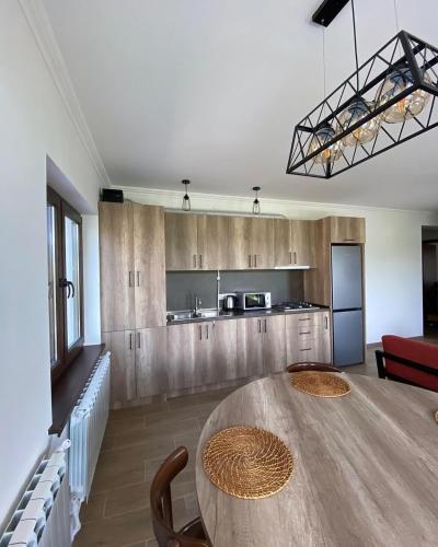 a kitchen with a wooden table and a dining room at Green Agarak Guest House near Dendropark, Stepanavan in Gyulagarak