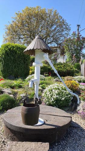 a water fountain with a umbrella on top of it at Venkovská usedlost Horšice in Horšice