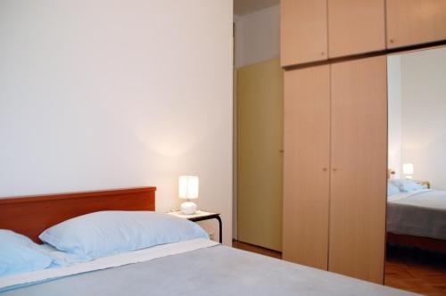 A bed or beds in a room at Apartment Rijeka with sea view