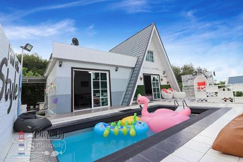 a house with a swimming pool in front of a house at The I-style pool villa in Ban Tao Than
