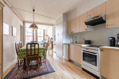 a kitchen with a table and a dining room at Factory of sweetness in Tienen