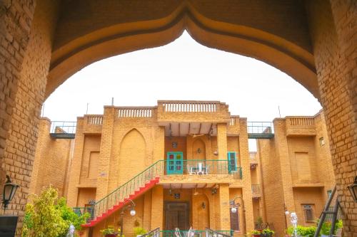 an archway view of a building with a balcony at WelcomHeritage Ranjitvilas in Amritsar