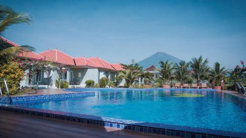 a large swimming pool in front of a resort at Seamount Hotel Amed in Amed