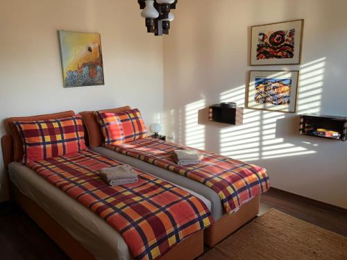 a bedroom with a bed with a plaid blanket at Holiday Home Andreja in Malinska