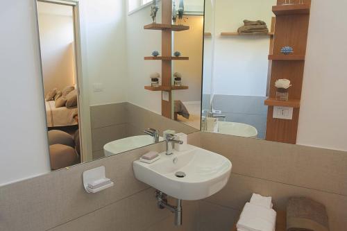 a bathroom with a sink and a mirror at SH Home in Palma Campania