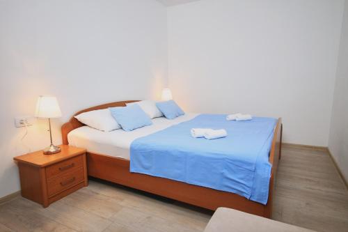 a bedroom with a bed with two towels on it at Apartman Lanterna in Viskovo