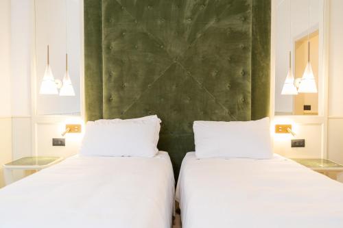 two beds sitting next to each other in a room at Tenuta Ciminata Greco in Rossano
