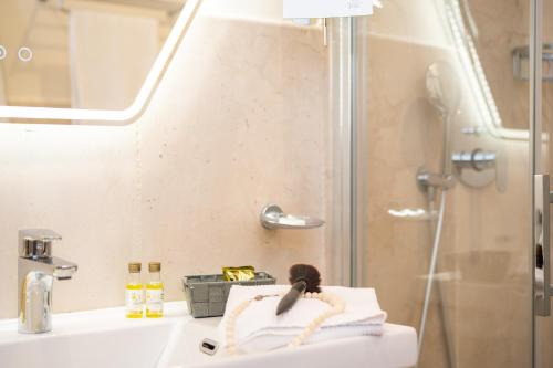 a bathroom with a sink and a shower at Tenuta Ciminata Greco in Rossano