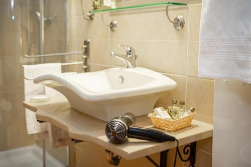 a bathroom with a white sink on a counter at Tenuta Ciminata Greco in Rossano