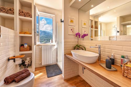 a bathroom with a sink and a mirror at La Paperella Blu Apartment in Termini Imerese