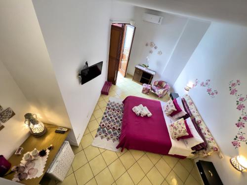 an overhead view of a bedroom with a purple bed at Due Relais - Panoramic Sea View Suites in Vietri sul Mare