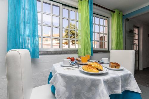 a table with a plate of food on it at Hotel Azul Praia in Altura
