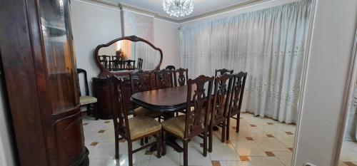 a dining room with a table and chairs and a mirror at Comfy 2 Bedrooms Apartment in Cairo 98-5 in Cairo