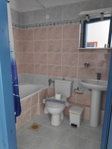 a bathroom with a toilet and a sink at Leonidas Studios & Apartments in Georgioupolis