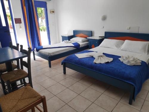 a bedroom with two beds with towels on them at Leonidas Studios & Apartments in Georgioupolis