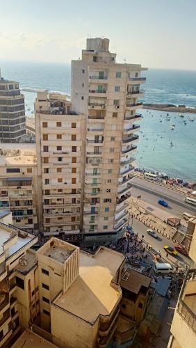 an aerial view of a city with buildings and the ocean at شقه فى ميامى بالاسكندريه مطله على البحر in Alexandria